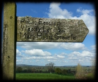 Weathered Footpath Sign in ancient landscape